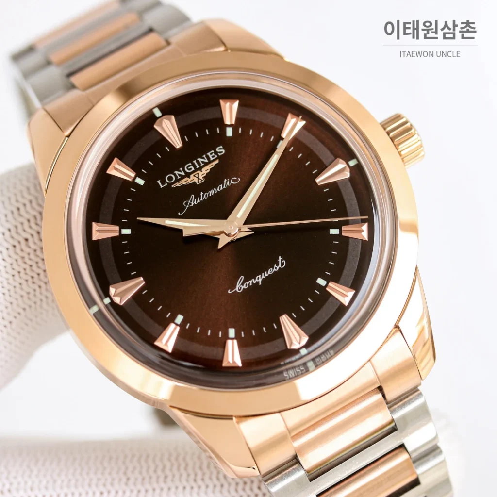 론진 콘퀘스트 헤리티지 스틸 쓰리핸즈 오토매틱 40mm 브라운 다이얼 로즈골드 브레이슬릿