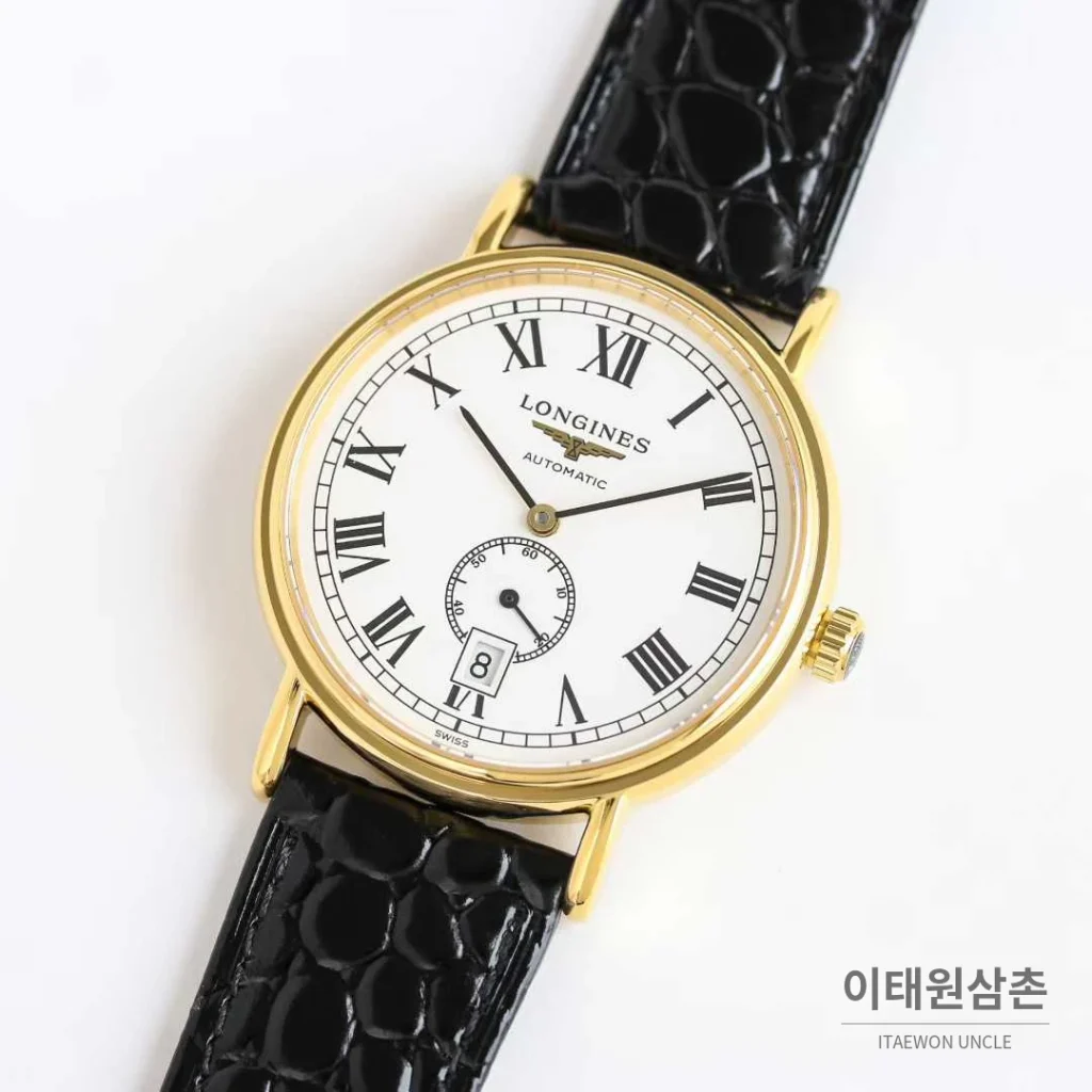 론진 엘레강스 스틸 화이트다이얼 로만인덱스 스몰세컨즈 오토매틱 38.5mm 블랙 가죽 스트랩 골드 베젤