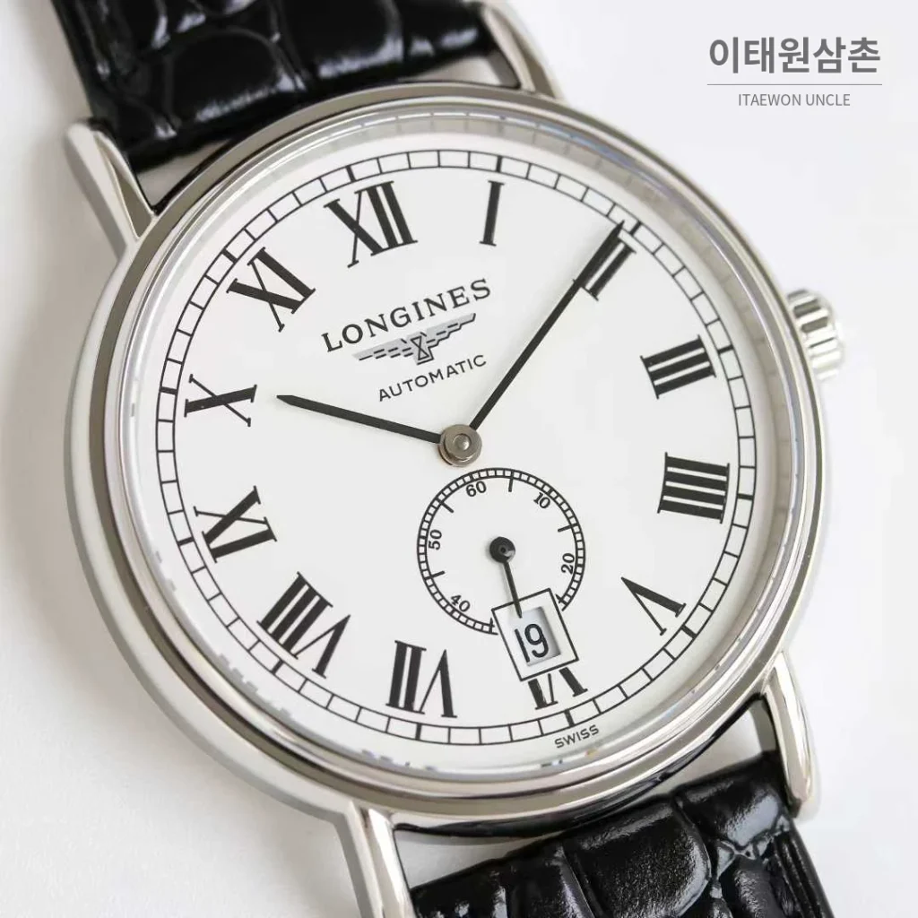 론진 엘레강스 스틸 화이트다이얼 로만인덱스 스몰세컨즈 오토매틱 38.5mm 블랙 가죽 스트랩