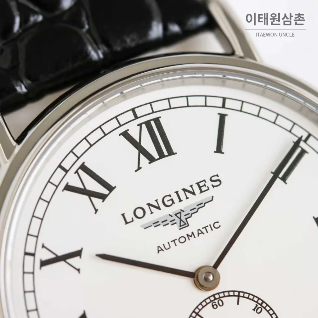 론진 엘레강스 스틸 화이트다이얼 로만인덱스 스몰세컨즈 오토매틱 38.5mm 블랙 가죽 스트랩