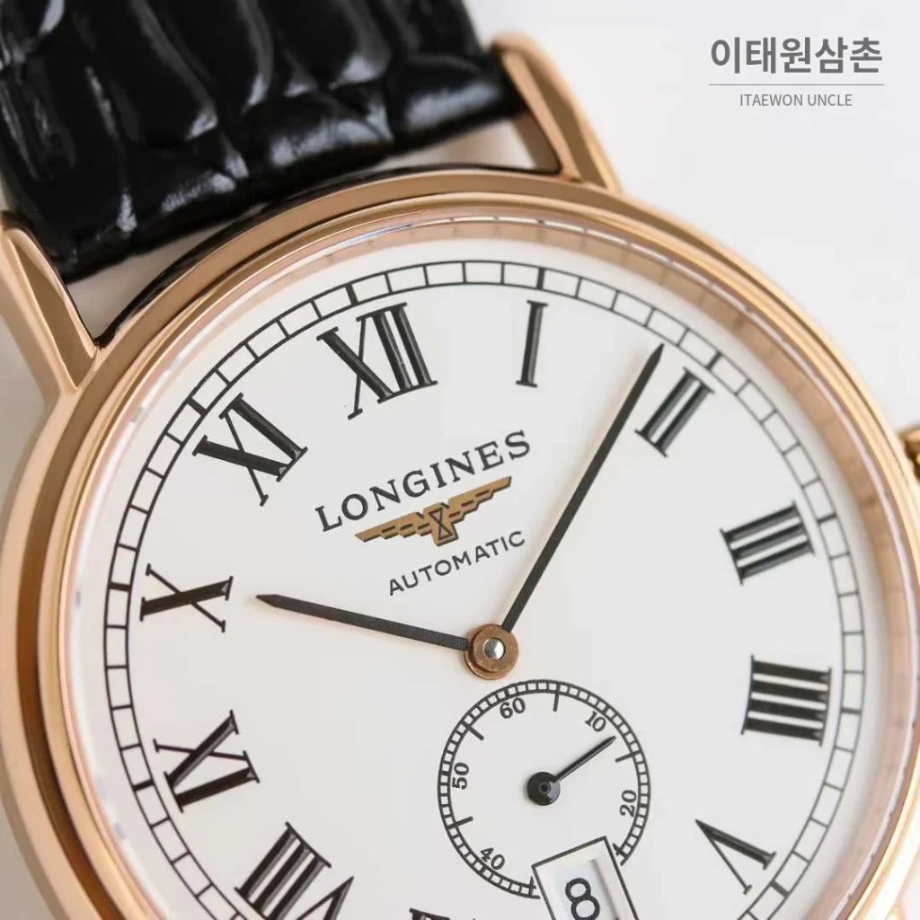 론진 엘레강스 스틸 화이트다이얼 로만인덱스 스몰세컨즈 오토매틱 38.5mm 블랙 가죽 스트랩 로즈골드 베젤